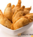Homemade Kajjikayalu or Garjalu filled with coconut and jaggery on a traditional plate.
