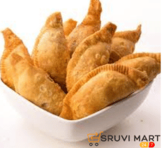 Homemade Kajjikayalu or Garjalu filled with coconut and jaggery on a traditional plate.